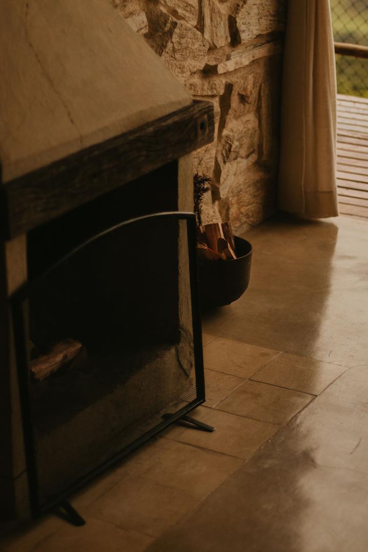 Fireplace opening, hearth, metal screen and stone wall